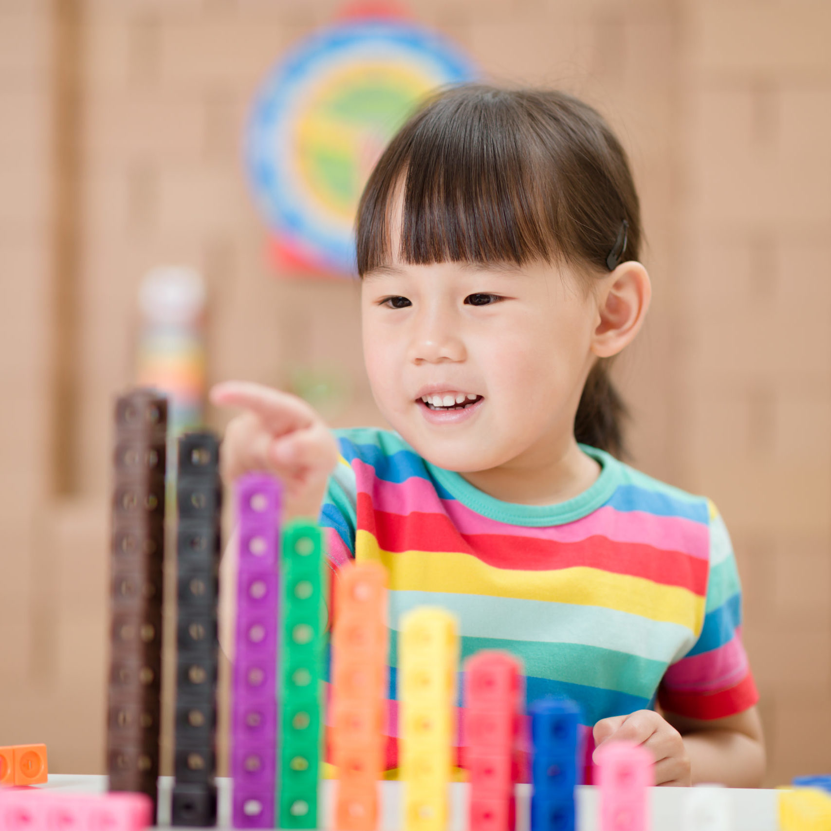 young girl play number sticks for home schooling